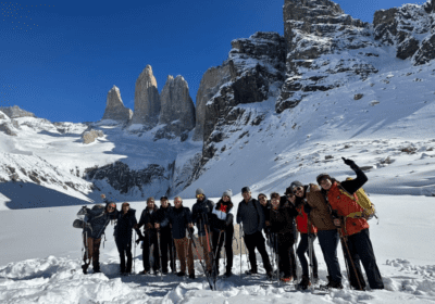 Base Torres winter trek group expedition with snow-covered granite towers and pristine winter landscape