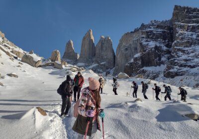 Torres del Paine winter guide leading small group to Base Torres with snow-covered granite towers and pristine winter landscape
