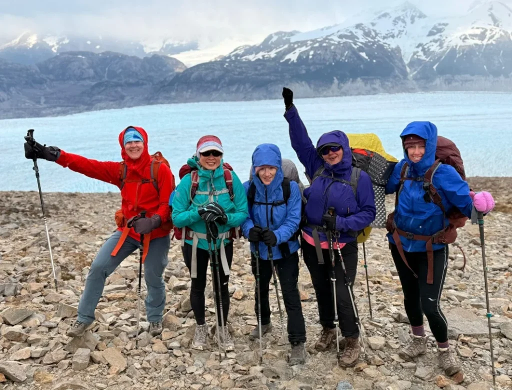 Hikers crossing John Gardner Pass on the O Circuit, with glacier and mountain views in Torres del Paine National Park.