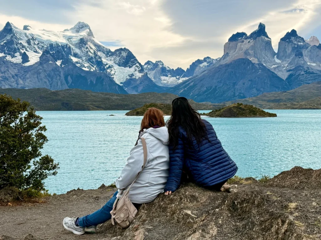 Travelers enjoying a scenic viewpoint with lake and mountain views in Torres del Paine National Park.