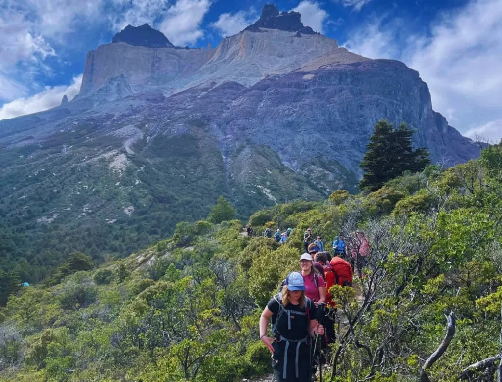 Hikers on the W Trek trail with views of Los Cuernos in Torres del Paine National Park.