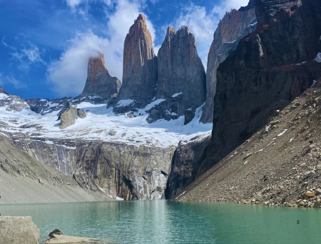 Base Torres viewpoint with the iconic granite towers and turquoise glacial lagoon in Torres del Paine National Park.