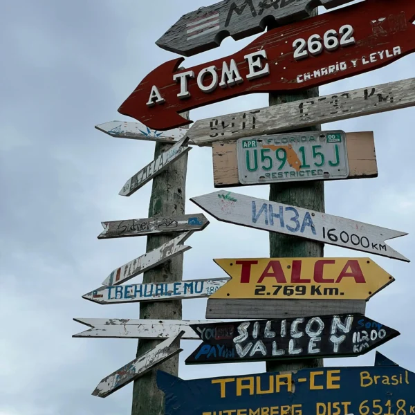 direcciones Colorful distance sign in Punta Arenas, showing routes and places across Chile and the world.