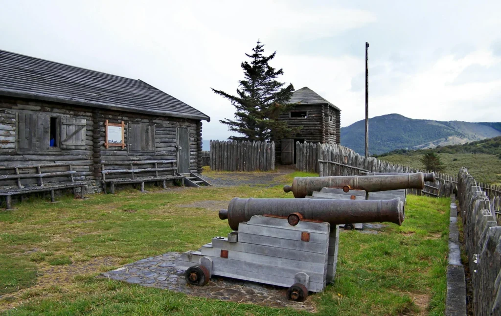 Historic wooden buildings and cannons at Fuerte Bulnes near Punta Arenas and the Strait of Magellan.