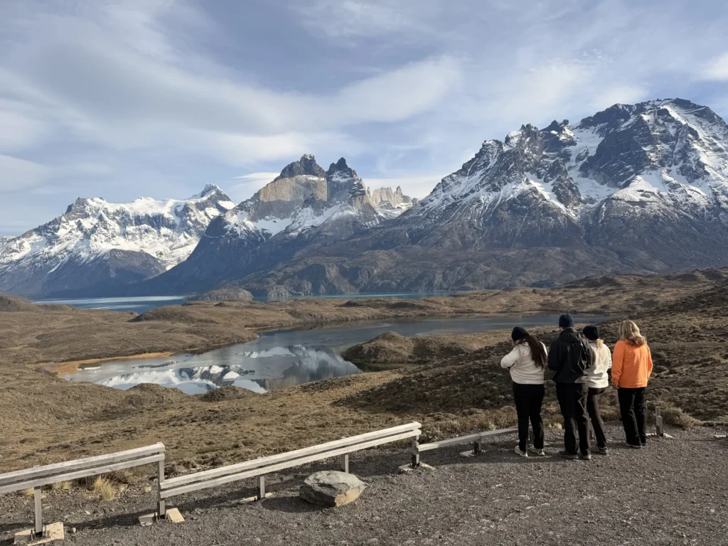 Travelers at a roadside viewpoint with the Paine massif, no hiking needed
